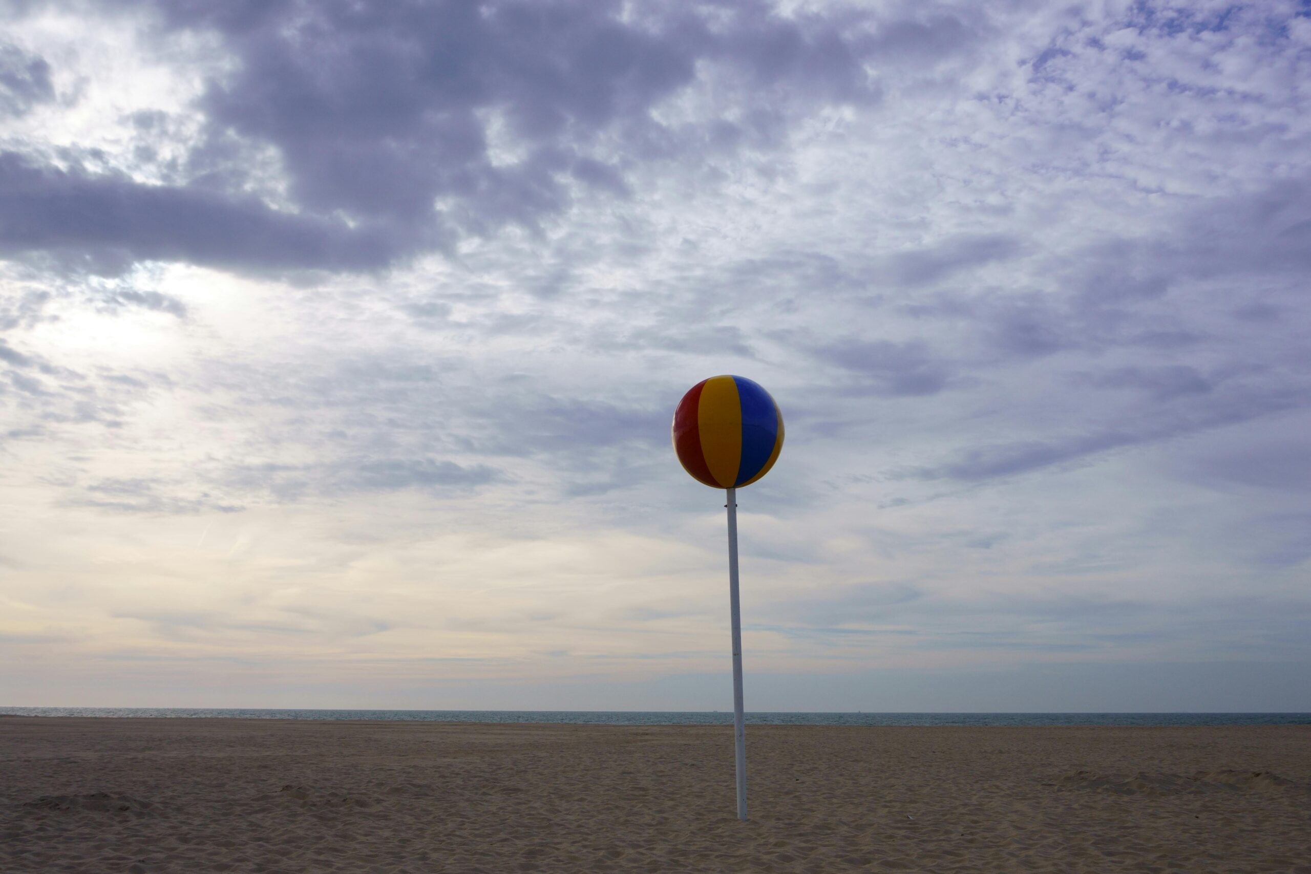 Rainbow Beach Ball on Brown Sand
