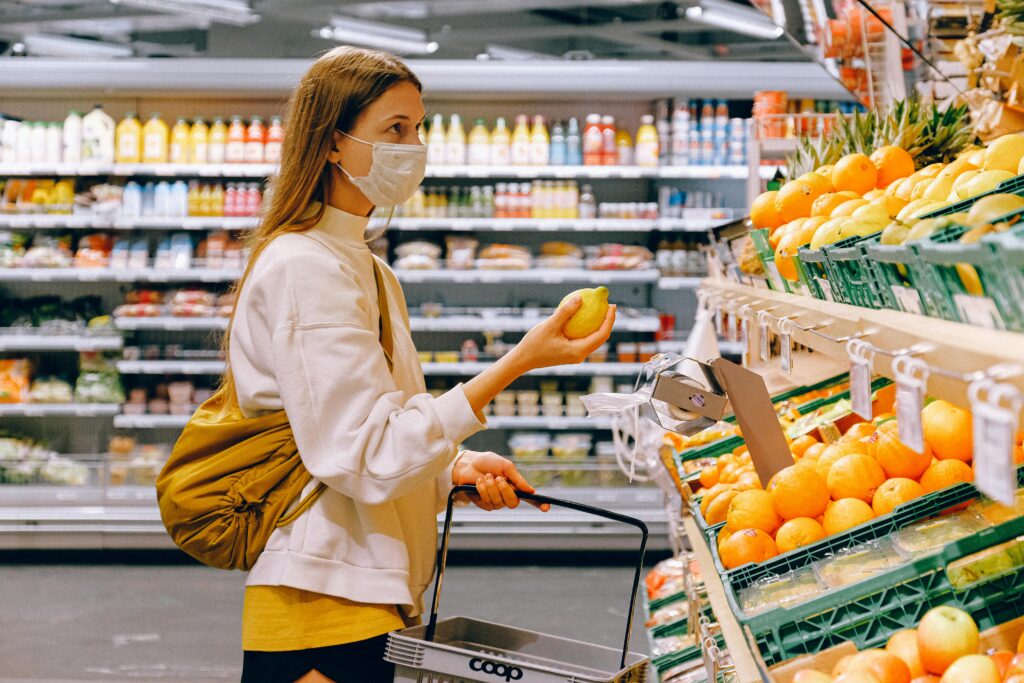 pexels-photo-3962285-3962285 Woman in Yellow Tshirt and Beige jacket Holding a Fruit Stand