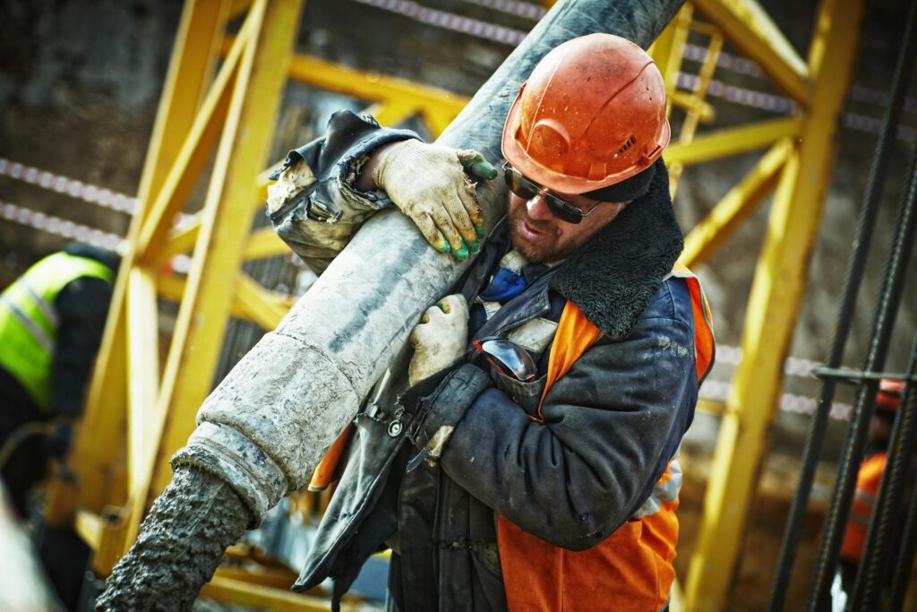 pexels-photo-585419-585419 Man Carrying Gray Pipe